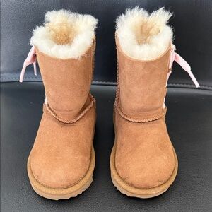 UGG Kids' Pala Boots in Chestnut Suede With Pink Ribbon Laces.